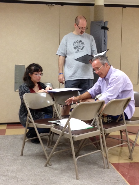 Director Molly Mattiani works with cast members Loren Seidner and Chris Johnson.